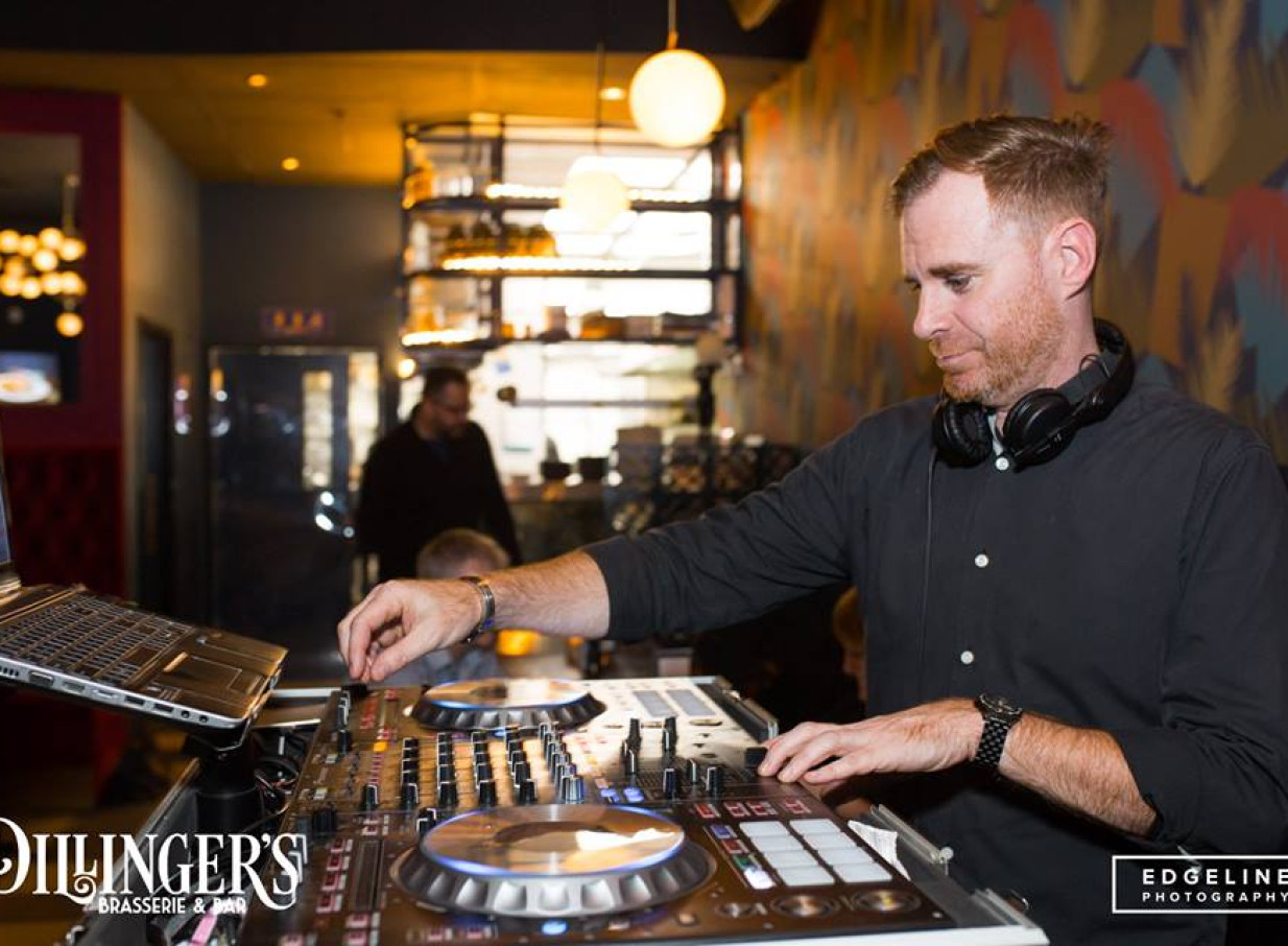 A DJ from Empire Agency Auckland performing a set in a retro-styled brasserie.