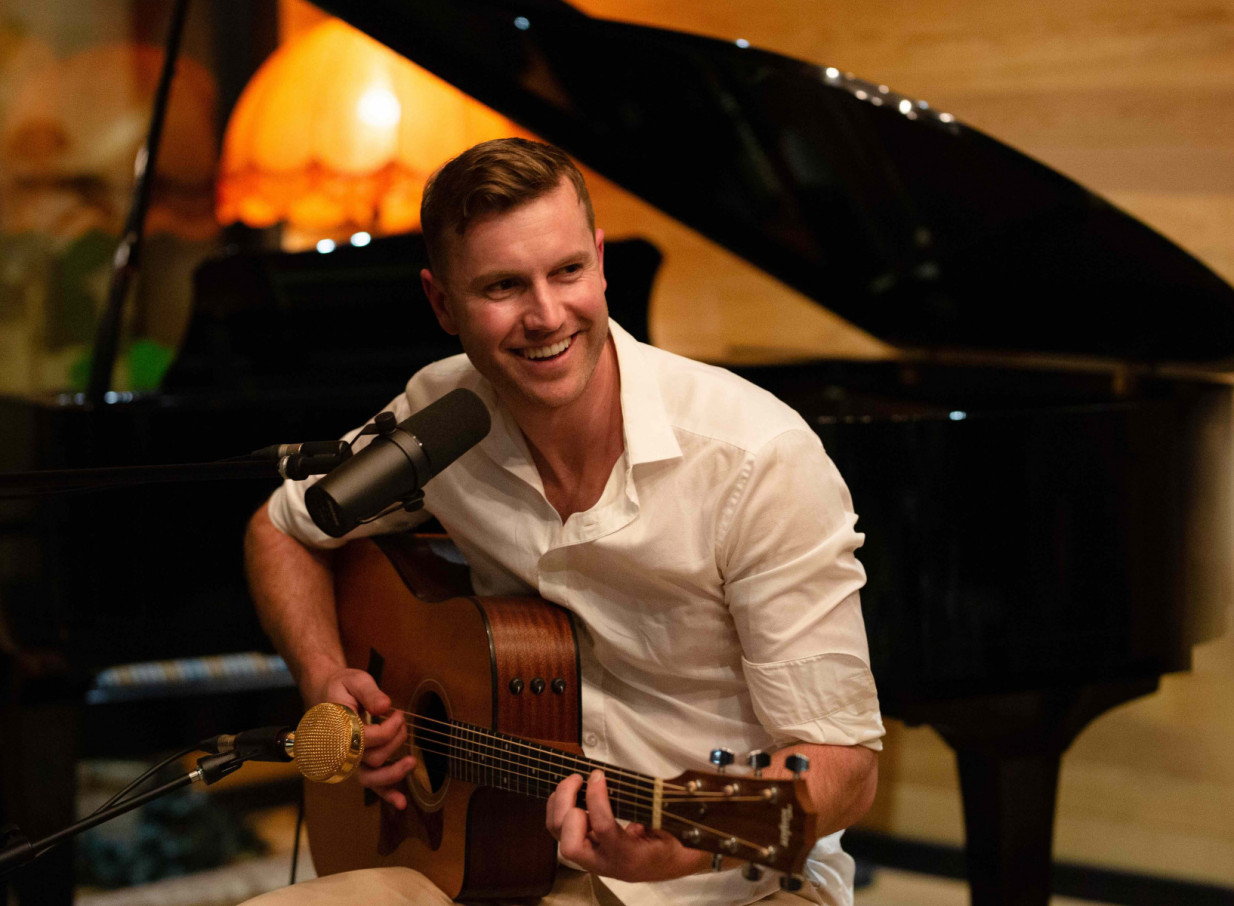 Daniel John, an Auckland acoustic artist, delivers a relaxed, soulful performance with his guitar and microphone.