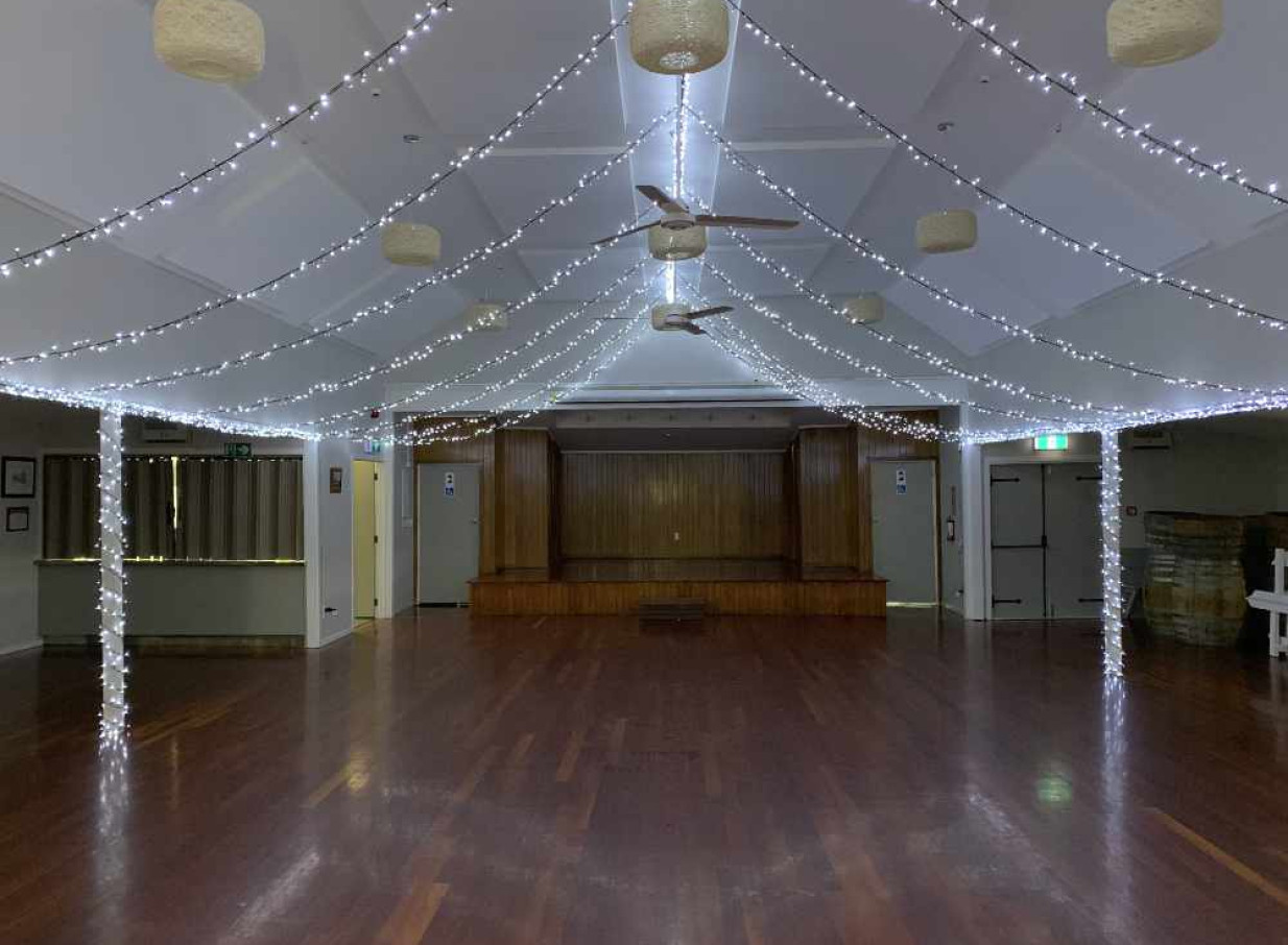 An indoor event space illuminated by Light and Leaf Co.'s signature fairy light canopy in Auckland.