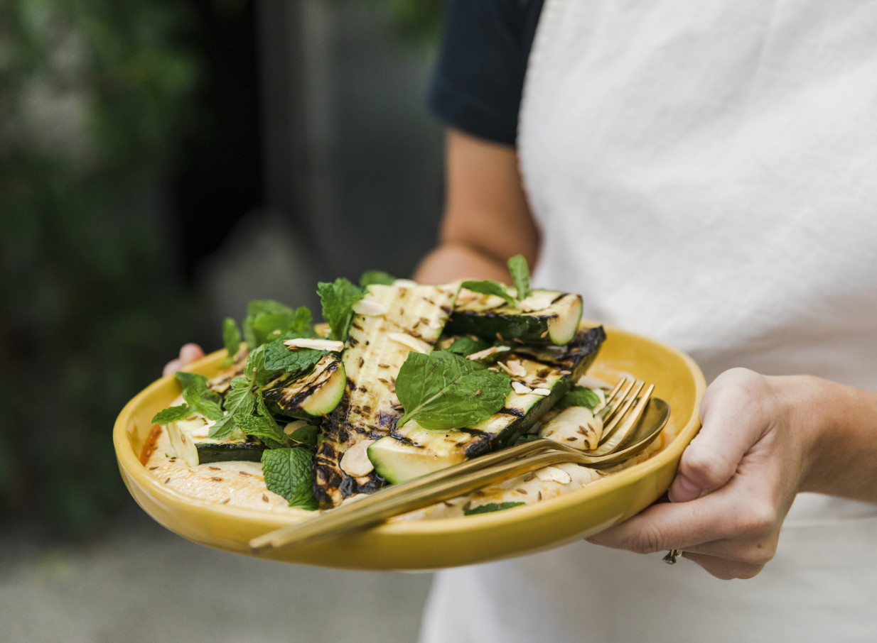 A beautifully plated grilled zucchini dish with mint and nuts, showcasing LittleWolf Auckland's creative catering style.