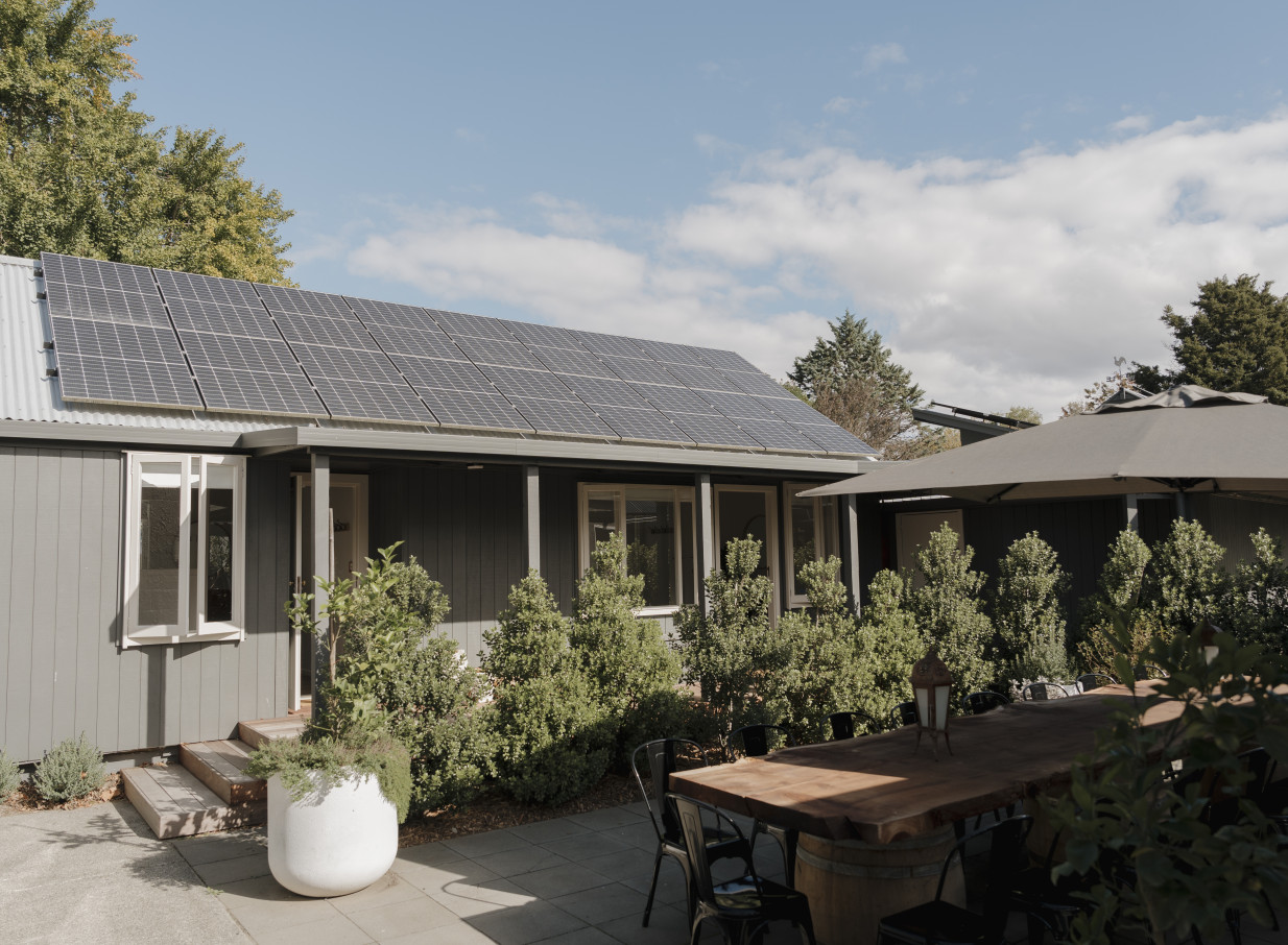 Omatua's modern country lodge in Hawke's Bay features an outdoor dining patio and solar panels.