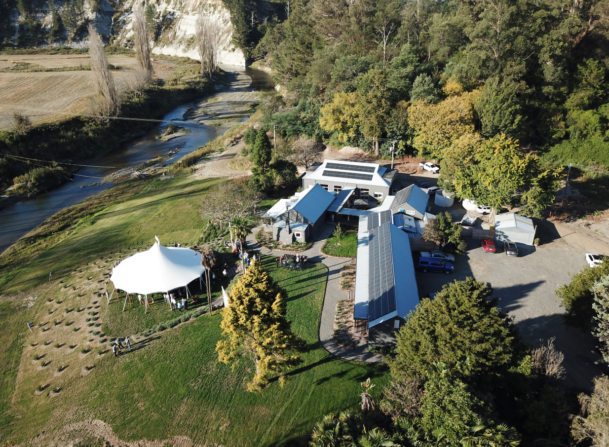An outdoor event with a white marquee is underway at Omatua, a rural riverside venue in Hawke's Bay.
