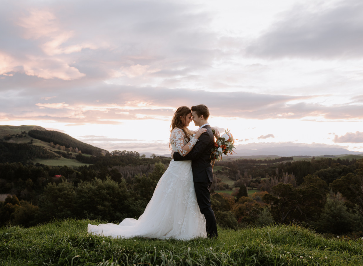 Romantic embrace at an outdoor wedding at Omatua, a scenic rural venue in Hawke's Bay.