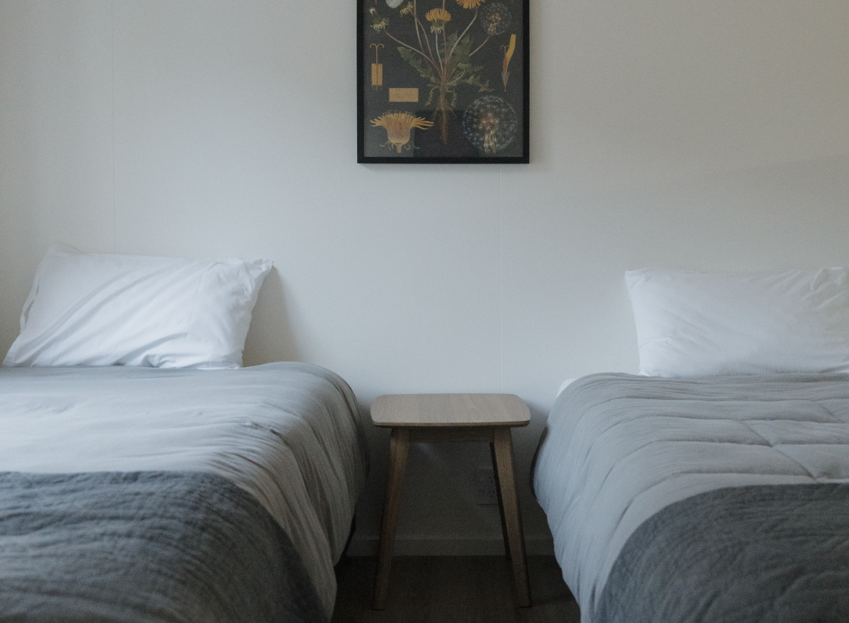 A bright, comfortable twin bedroom in the rural Omatua lodge in Hawke's Bay.
