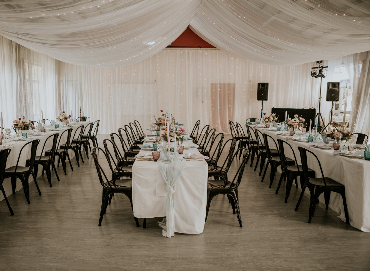 An elegant indoor event reception at Omatua, a rural Hawke's Bay lodge, featuring draped ceilings and fairy lights.