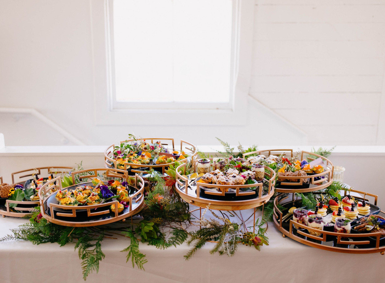 The Canapé Room in Wellington presents a beautifully styled canapé spread on elegant trays within its chic, light-filled loft space.