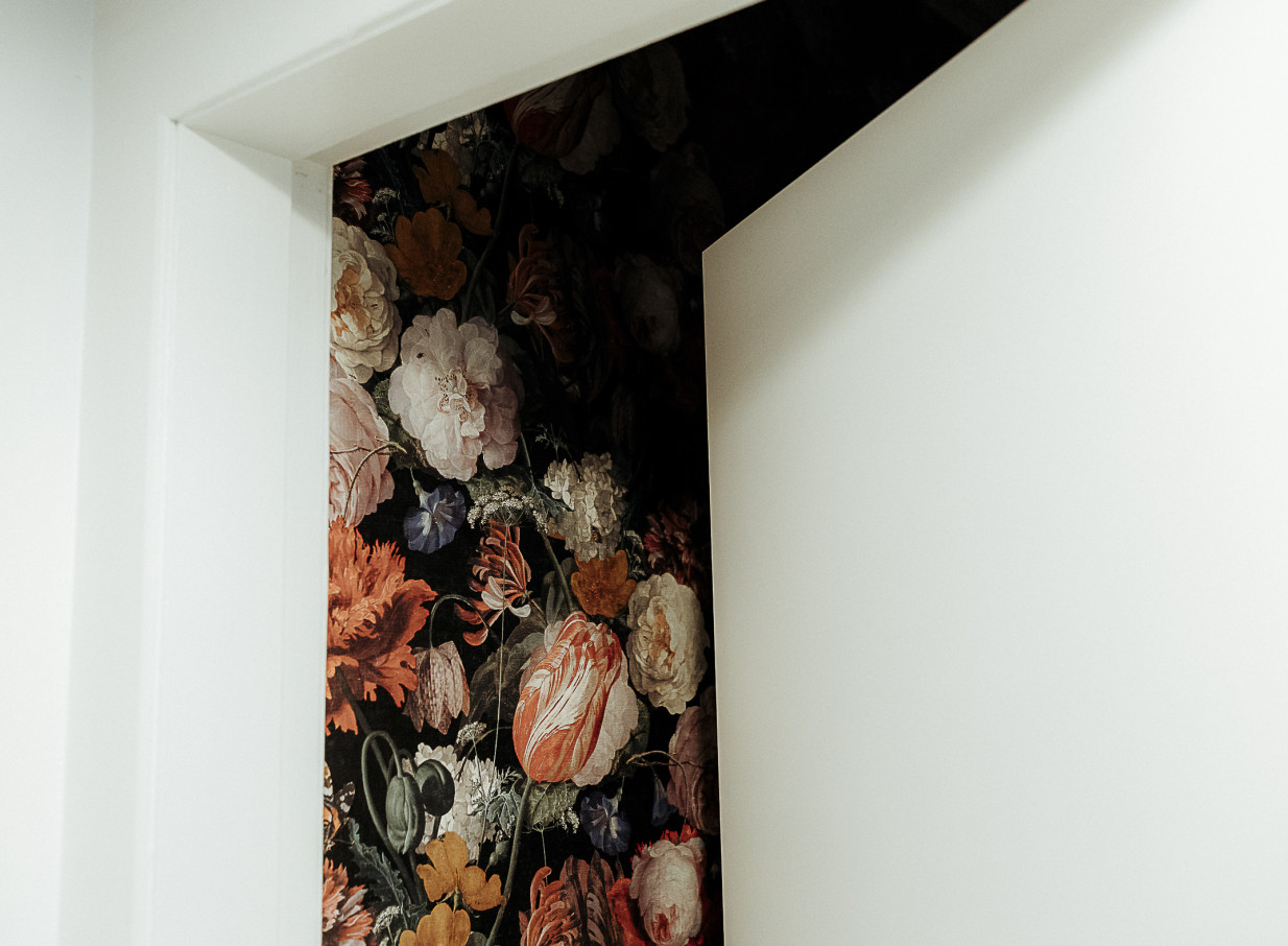 An elegant, intimate interior at The Canapé Room, Wellington, features ornate floral wallpaper, adding to its vintage charm.