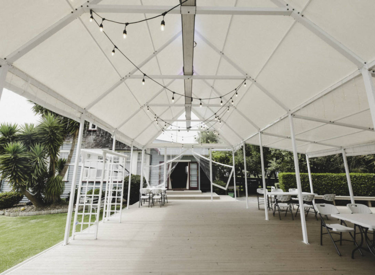 A charming covered deck or marquee with string lights at the homely Connemara Country Lodge in Auckland.