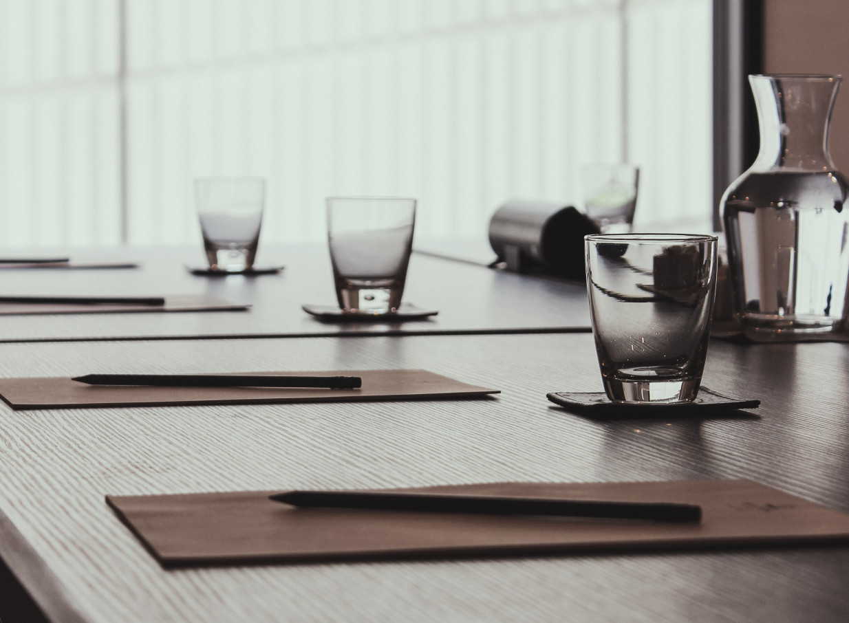 An elegant, contemporary meeting room at Bolton Hotel in Wellington, featuring individual place settings.
