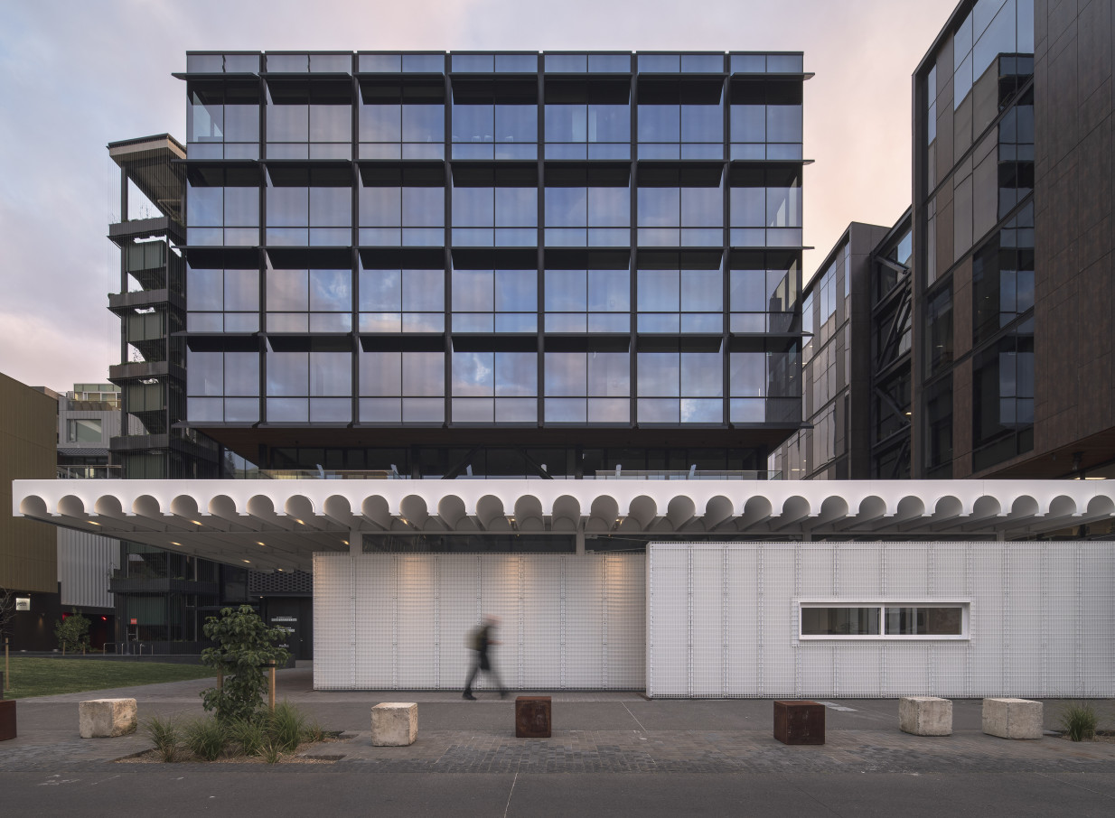 The contemporary, industrial-inspired exterior of The Annex, 10 Madden Street, Auckland, with its glazed facade and white arched canopy.