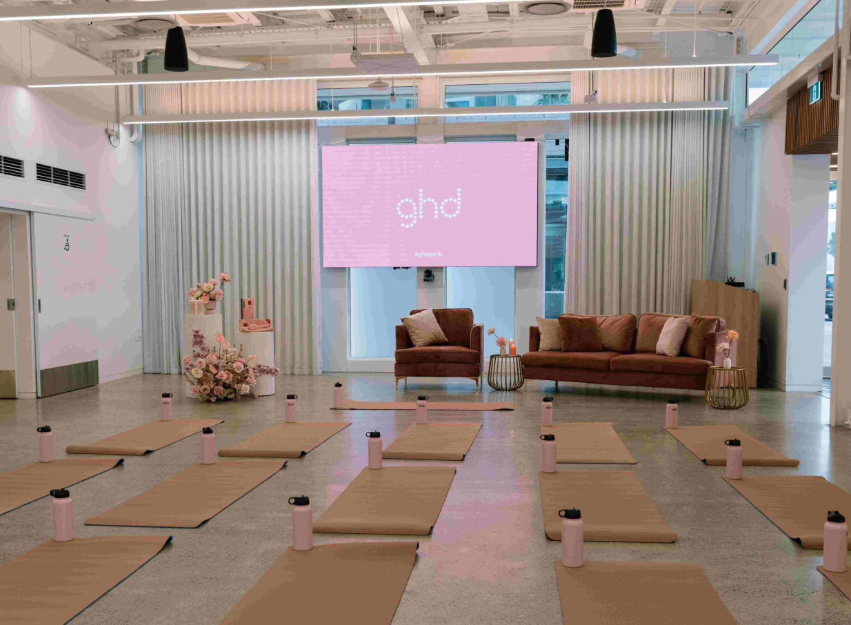 This light-filled, contemporary wellness event space at The Annex in Auckland's Wynyard Quarter features yoga mats and lounge seating.
