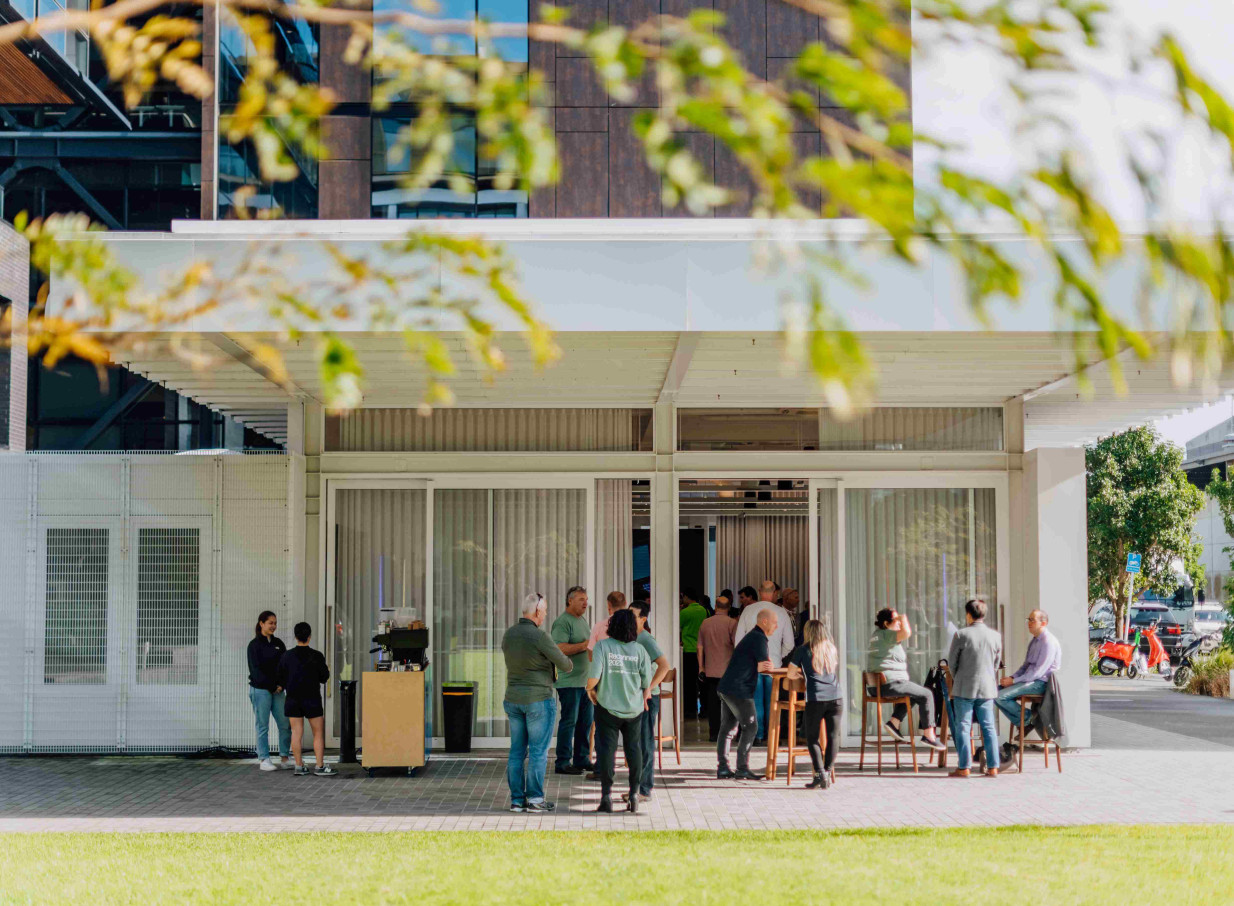 People gather in the outdoor forecourt of The Annex, a contemporary event venue by Precinct Flex in Auckland.