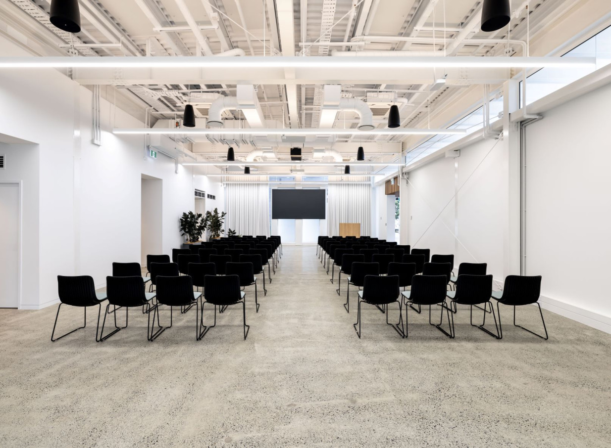 A contemporary, industrial-chic event space at The Annex, 10 Madden Street by Precinct Flex in Auckland, arranged theatre-style for presentations.