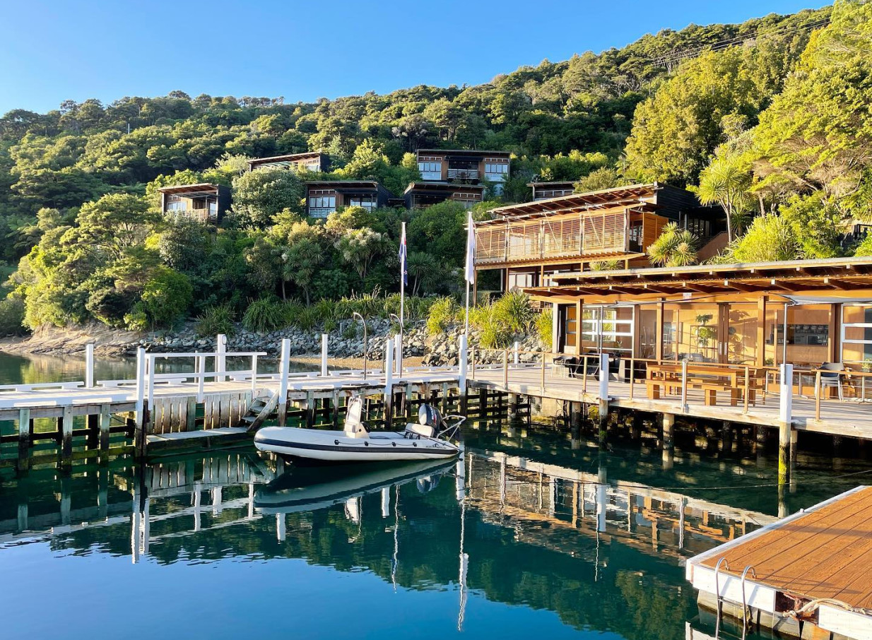 Bay of Many Coves Resort's modern wooden suites blend into native bush overlooking the Marlborough Sounds, with a private dock.