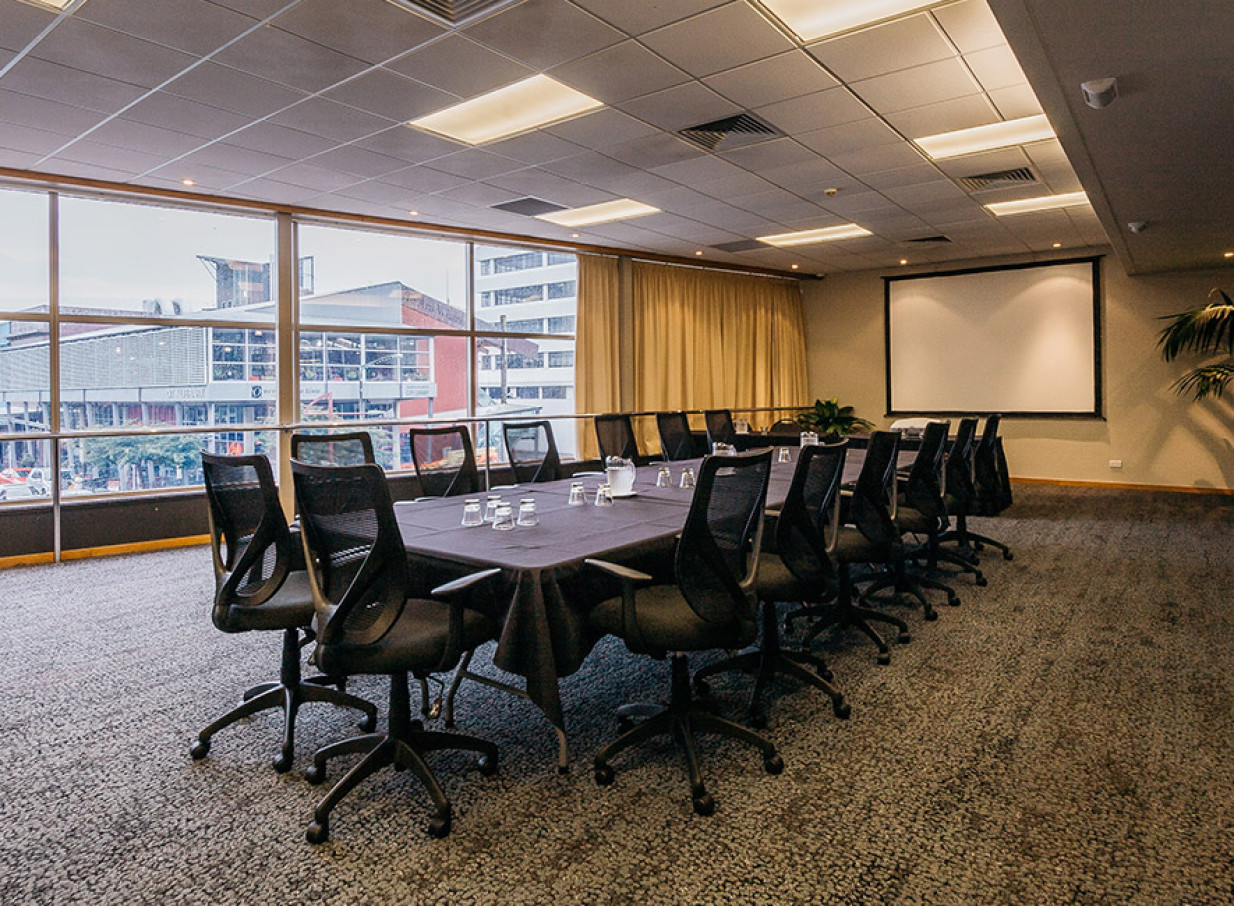 A modern conference room with city views through large windows at Palmy Conference + Function Centre, Palmerston North.