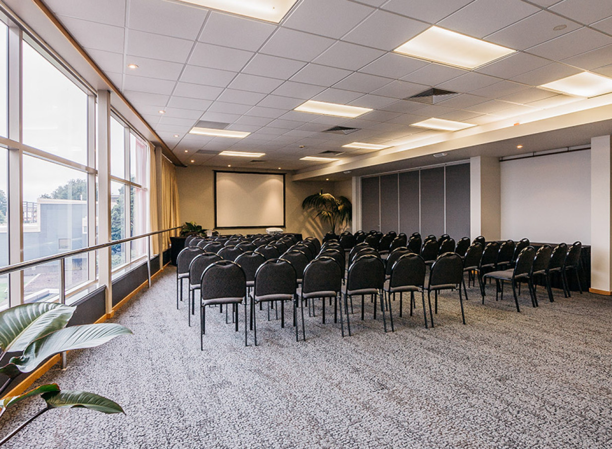 An airy, modern conference room with theatre-style seating at Palmy Conference + Function Centre in Palmerston North.