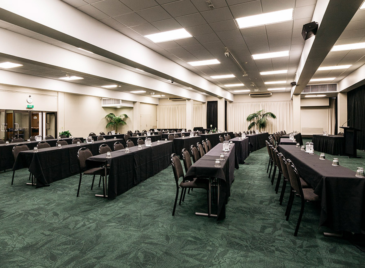 A modern, versatile conference room with a classroom setup at Palmy Conference + Function Centre, Palmerston North.