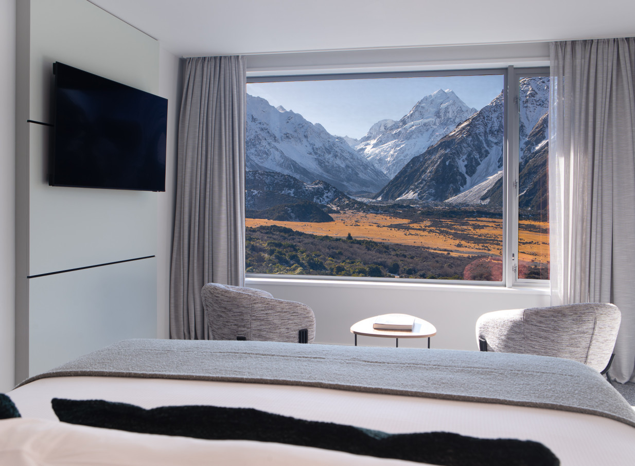 A modern hotel room at The Hermitage Hotel, Aoraki / Mount Cook, Canterbury, offering panoramic views of snow-capped peaks.