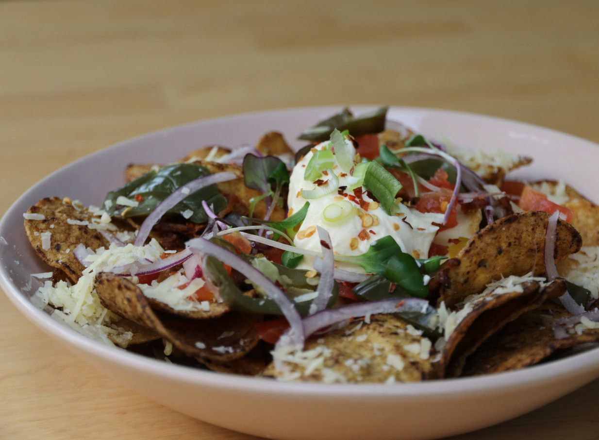 A fresh sharing plate of loaded corn chips with cheese and jalapeños from Rosanna's Garden Bar & Eatery, an urban oasis in Auckland.