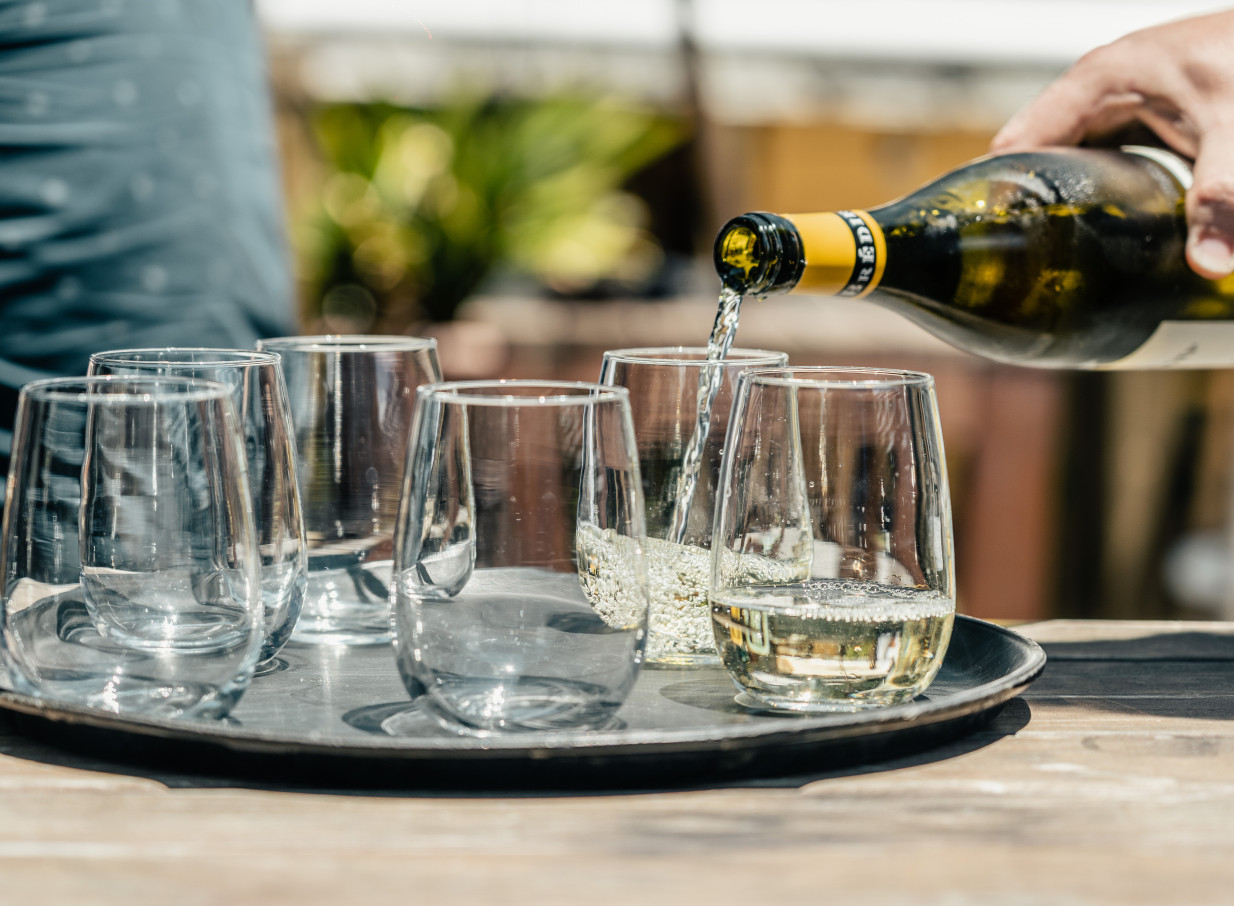 White wine pouring in the Parisian-inspired bohemian setting of 39 Ponsonby's outdoor garden in Auckland.