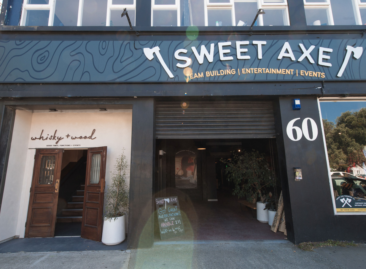 The Wellington entrance of Whisky & Wood features inviting open wooden doors leading to its industrial-elegant loft event space.