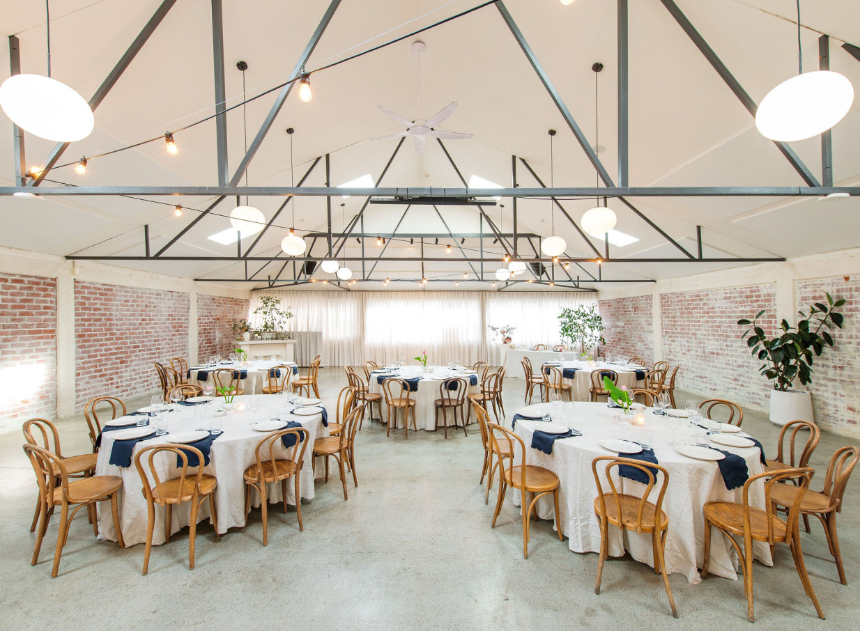This industrial New York loft-style dining area at Whisky & Wood in Wellington features washed-brick walls and high ceilings.