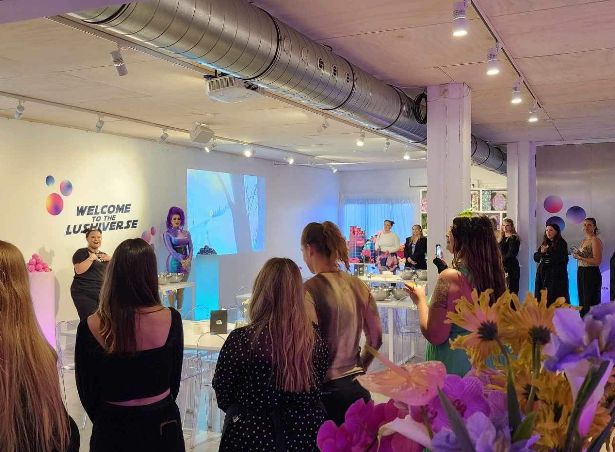 Guests attend an indoor presentation in the modern industrial event space of Space On Crummer, Auckland.
