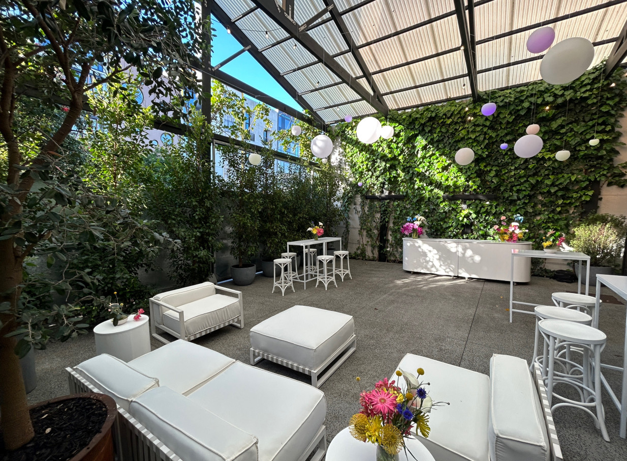 Space On Crummer, Auckland, offers a chic, industrial-style covered courtyard event space with lush greenery and lounge seating.