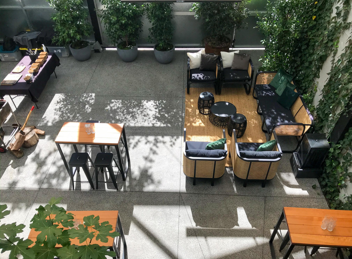 Relaxed outdoor seating in the industrial-chic courtyard of Space On Crummer, Auckland.