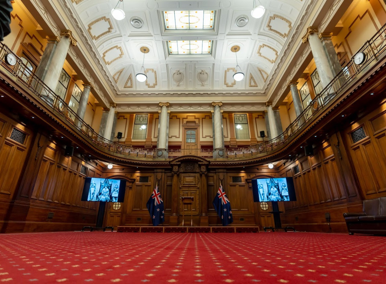 A grand Legislative Council Chamber event space with Italian marble pillars and rimu paneling at Huihui, Wellington.