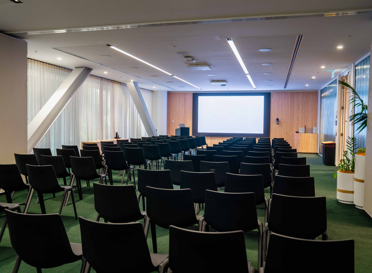 A modern theatre-style presentation room at the contemporary Bowen Campus by Precinct Flex in Wellington, featuring advanced AV technology and clean design.