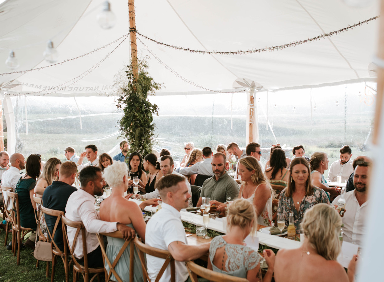 A rustic tented reception with natural decor at Te Karaka Lodge, a luxurious rural escape in Waikato.