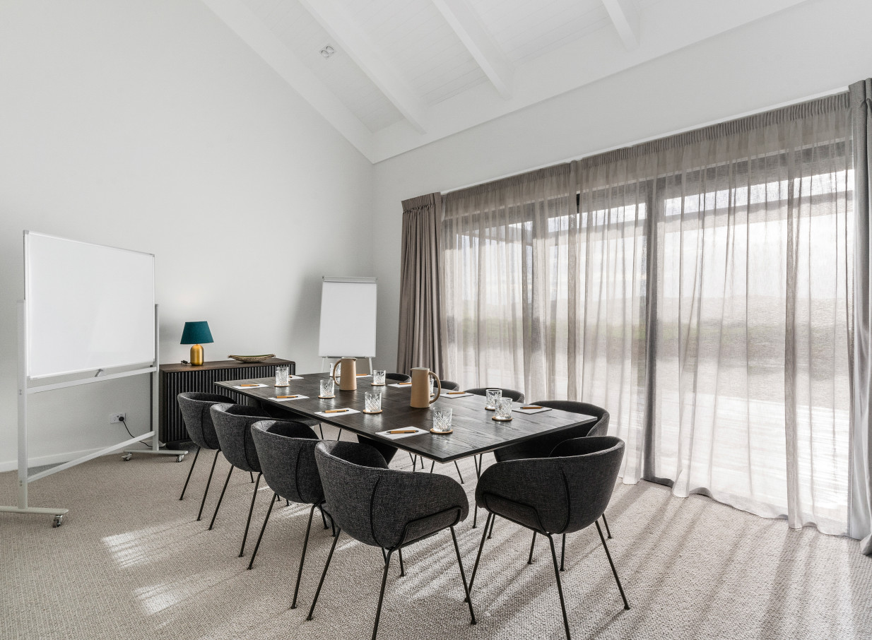 A contemporary meeting room with ample natural light at Te Karaka Lodge, a luxury lodge in rural Waikato.