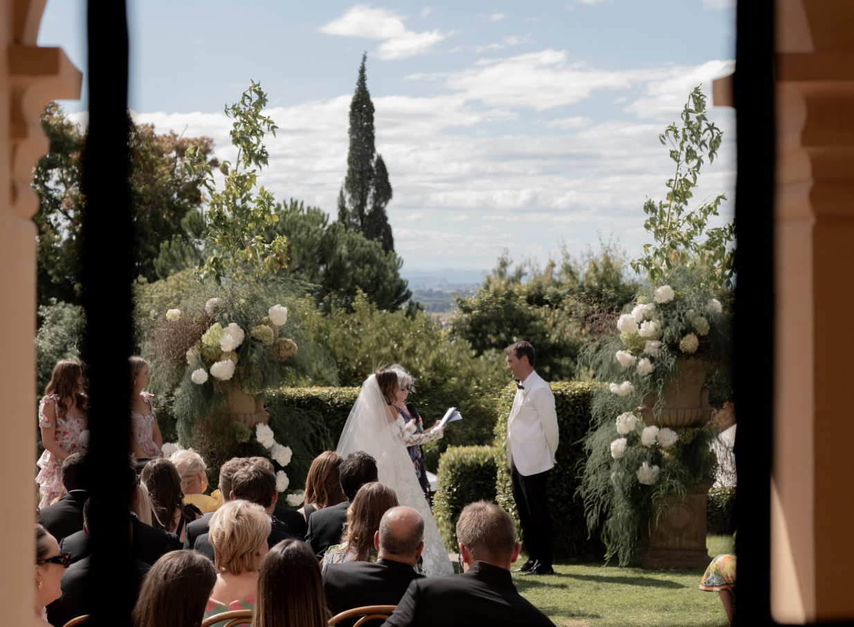 An outdoor wedding ceremony takes place at the Mediterranean-inspired 1920s Kōtare Estate in Hawke's Bay.