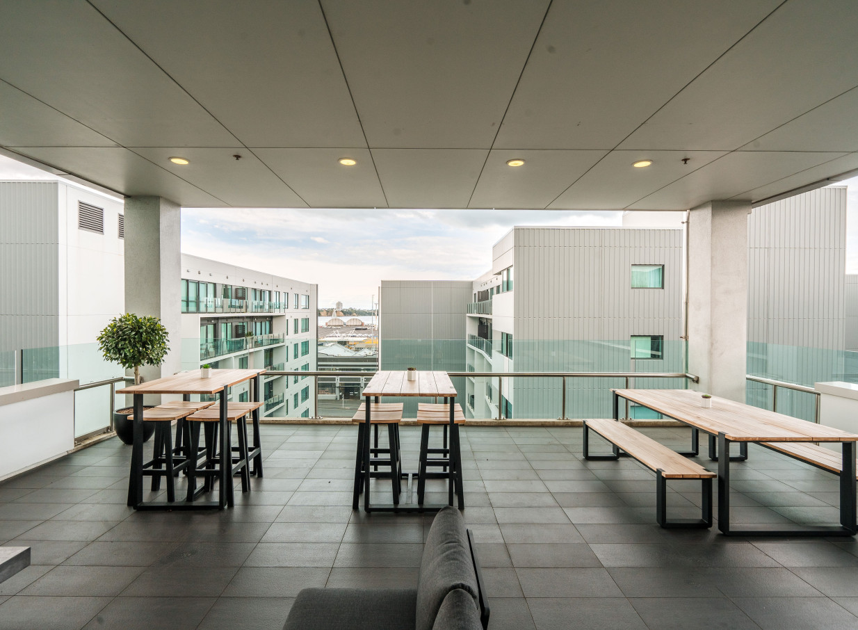 A modern outdoor terrace at CA Auckland Conference Centre, Auckland, features stylish seating and city views.