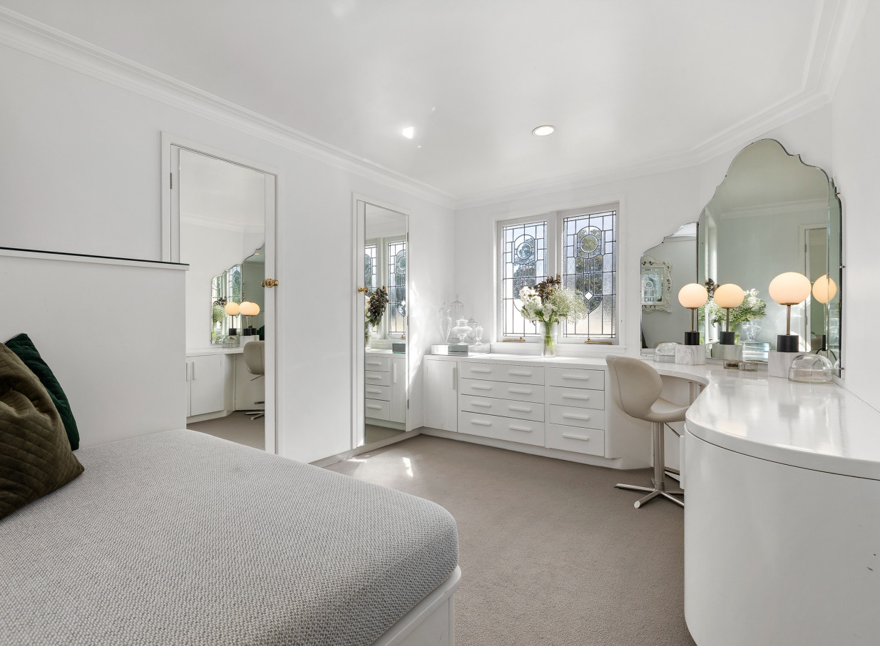 The elegant Spanish Mission bridal suite at Puketutu Island Estate in Auckland features beautiful stained glass windows and vanity mirrors.