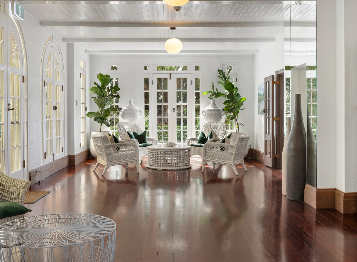 The bright, elegant seating area within the Spanish Mission homestead of Puketutu Island Estate, Auckland.