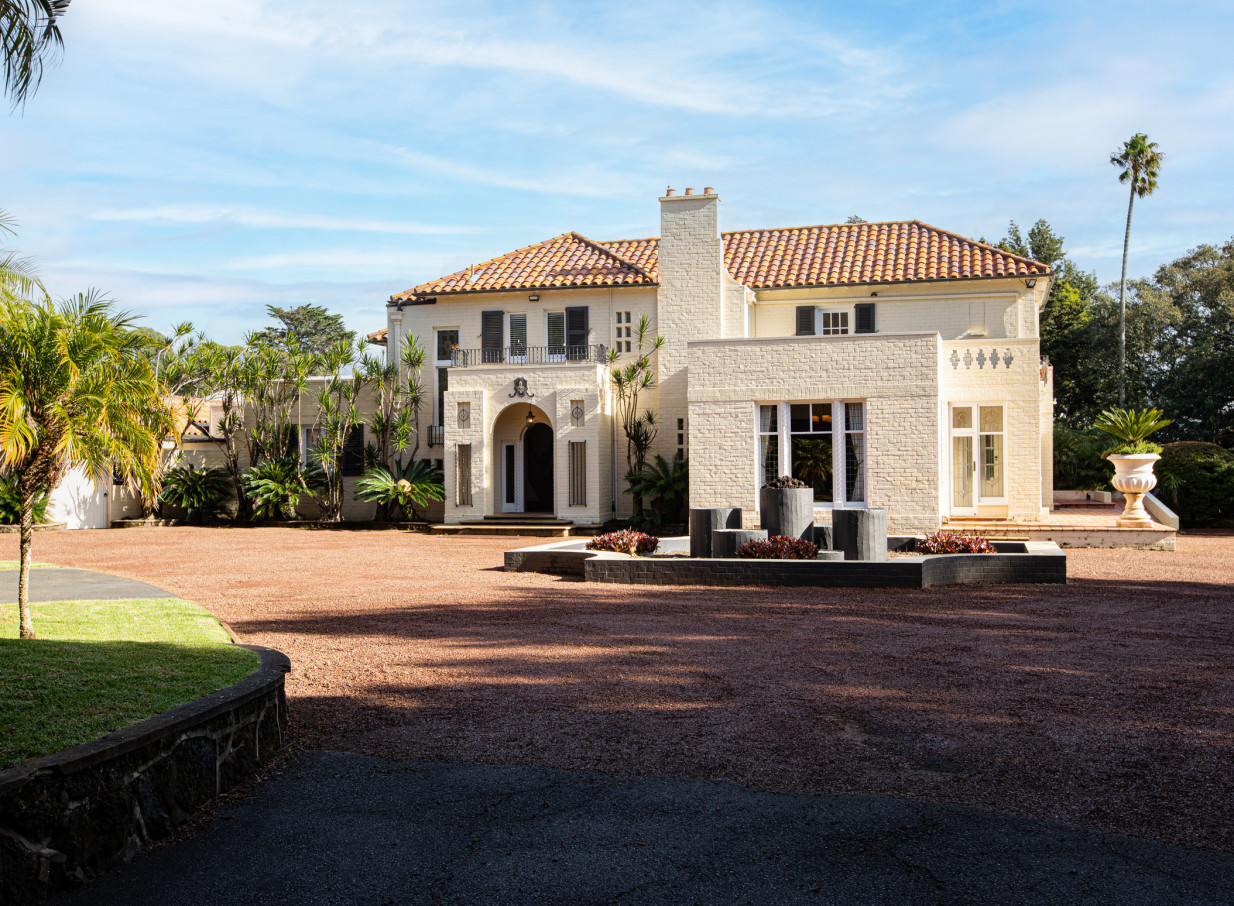 The welcoming Spanish-style homestead entrance at Puketutu Island Estate, Auckland.