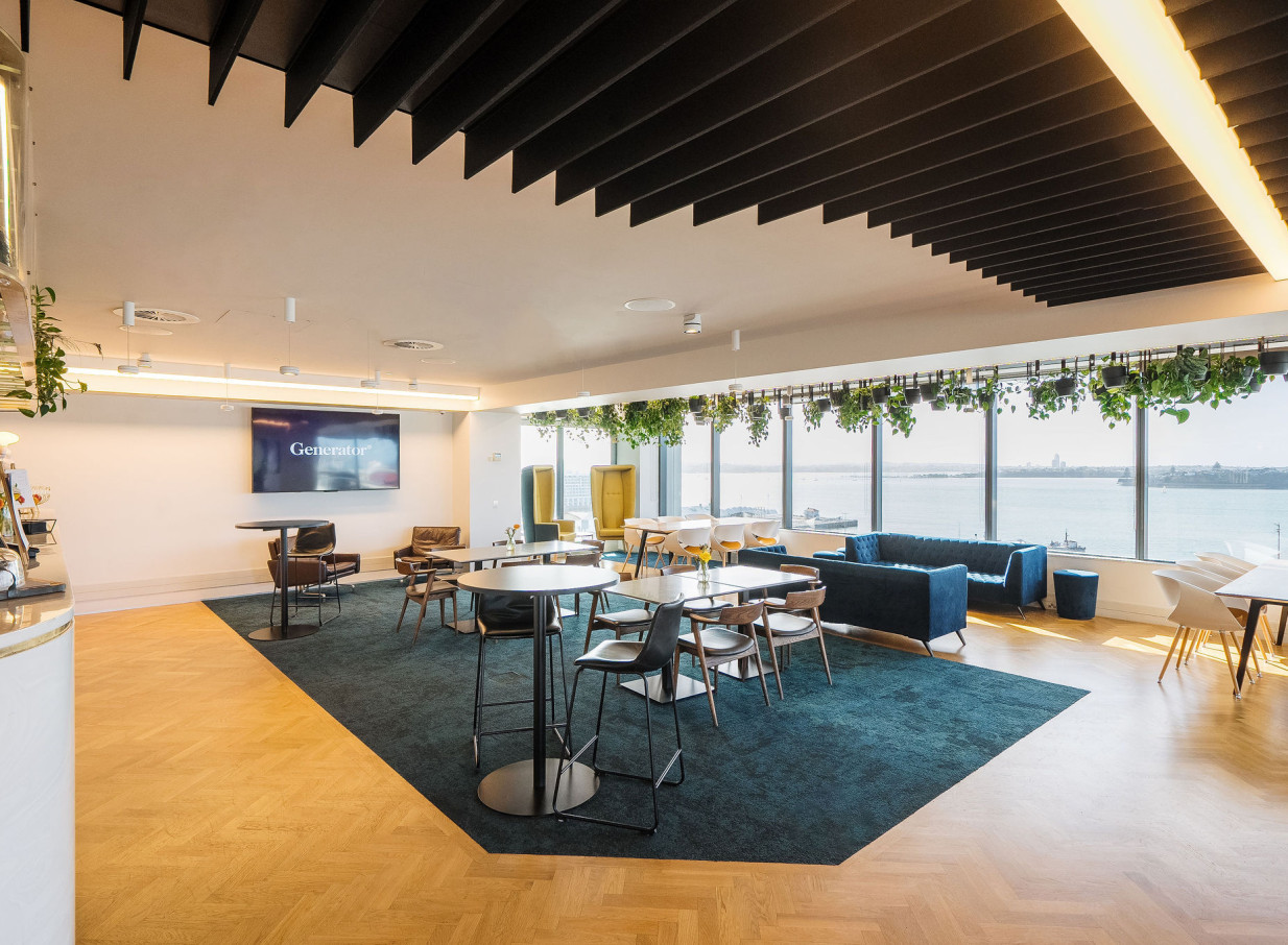 Britomart Place by Precinct Flex, Auckland, presents a chic co-working lounge with hanging greenery and stunning harbor views.