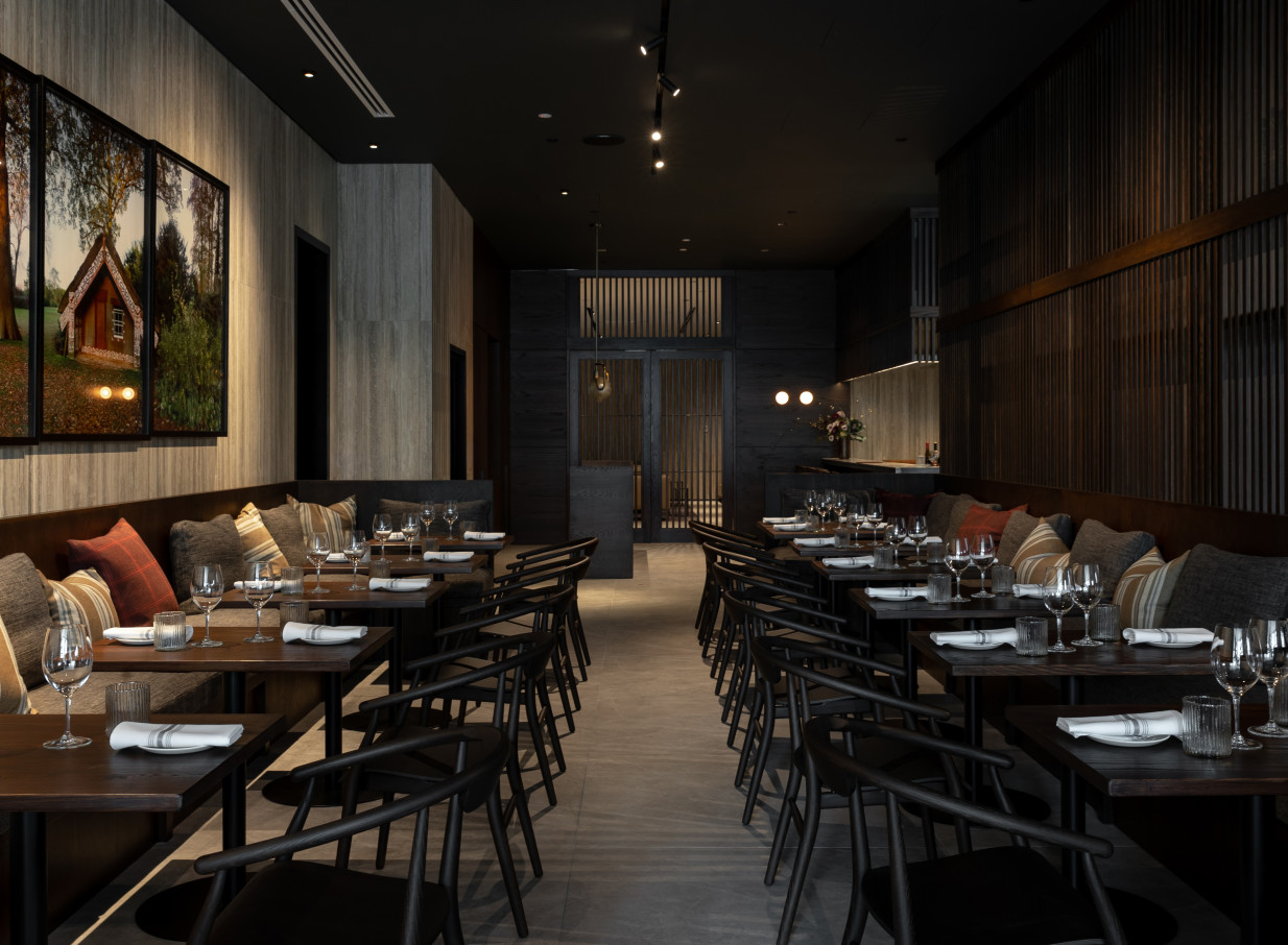 Dark wood and elegant banquettes define the sophisticated dining room at Onslow, Auckland.