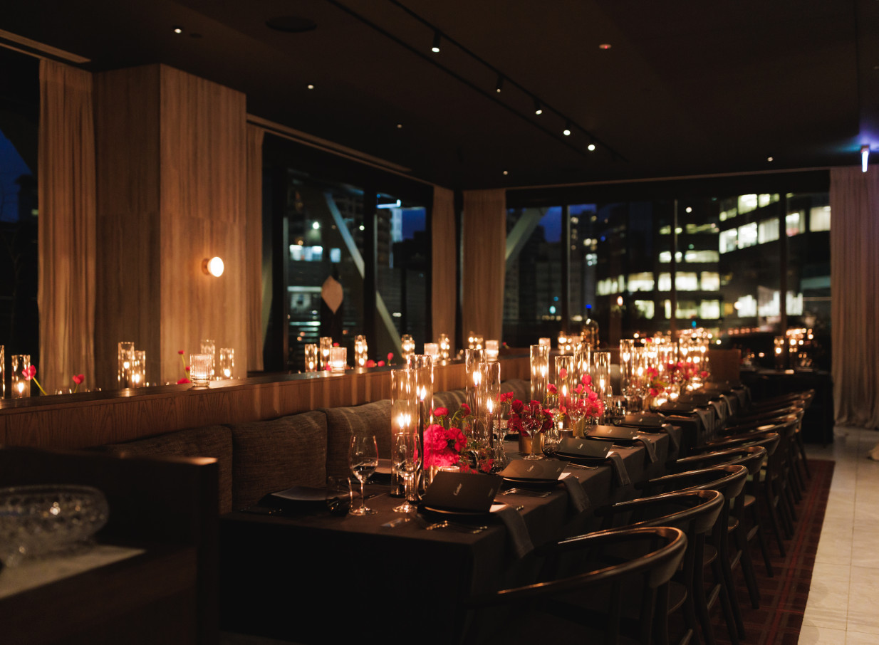 An intimate, candlelit private dining room at Onslow, Auckland's sophisticated modern restaurant, features a dark oak interior.