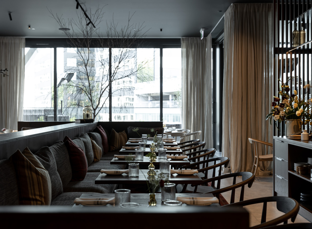 Onslow, Auckland, offers a sophisticated and relaxed modern dining room with dark wood tables, plush banquettes, and window views.