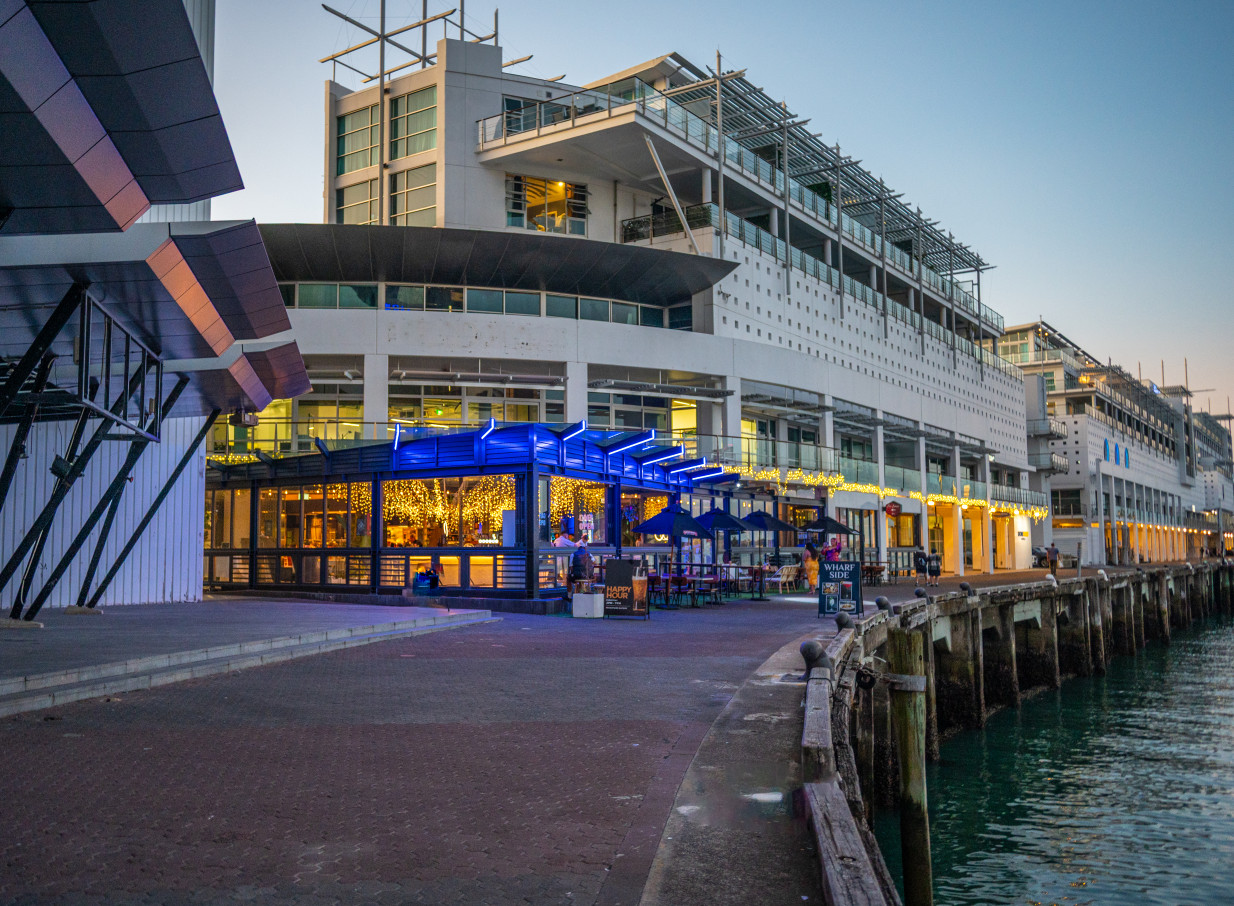 Wharfside Function Centre, Auckland, offers modern waterfront dining with an elegantly lit outdoor bar area.