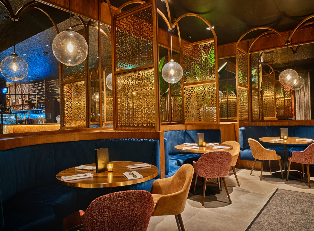 Christchurch's 1851 Social Bar showcases a modern speakeasy lounge with plush blue velvet booths and intricate golden screens.