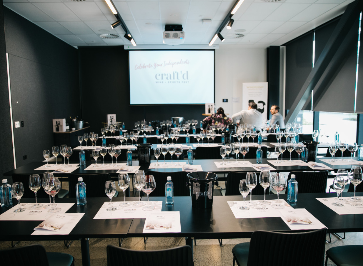 A sleek, contemporary event space at 12 Madden St by Precinct Flex in Auckland is arranged for a tasting event.