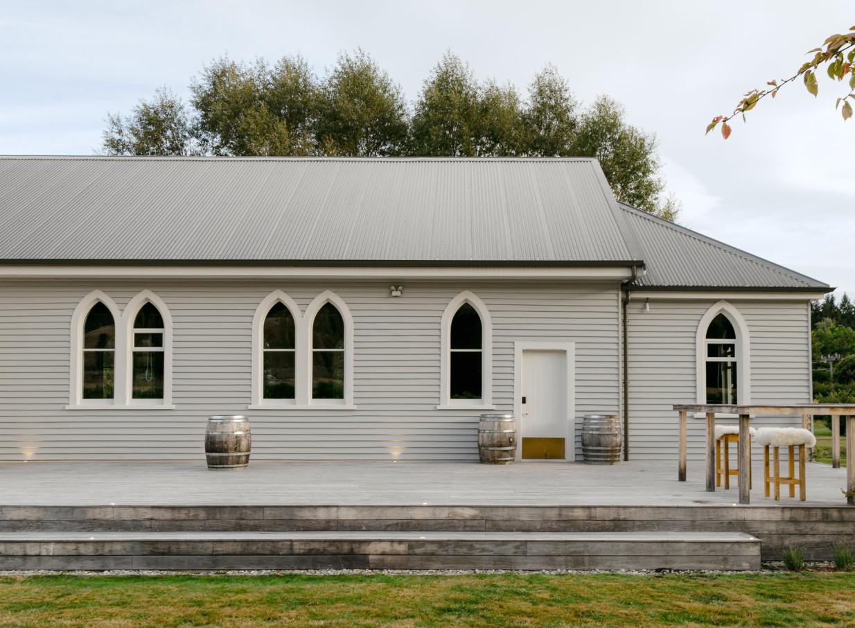 Waikākā Church in Queenstown, a restored Gothic-revival chapel, offers an inviting outdoor deck and striking arched windows.
