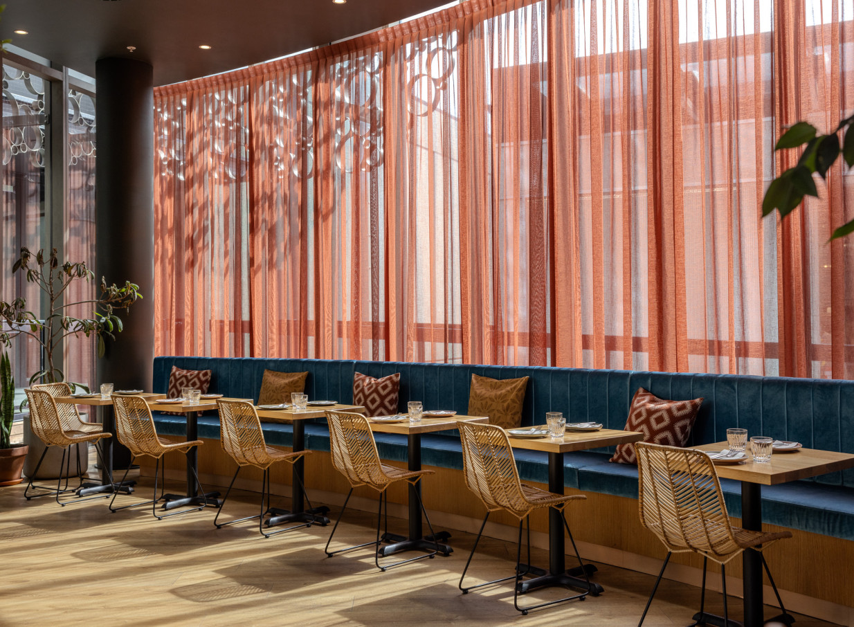 Bar Franco's sophisticated Christchurch dining room boasts modern Italian flair, with blue velvet seating and sunlit sheer drapes.