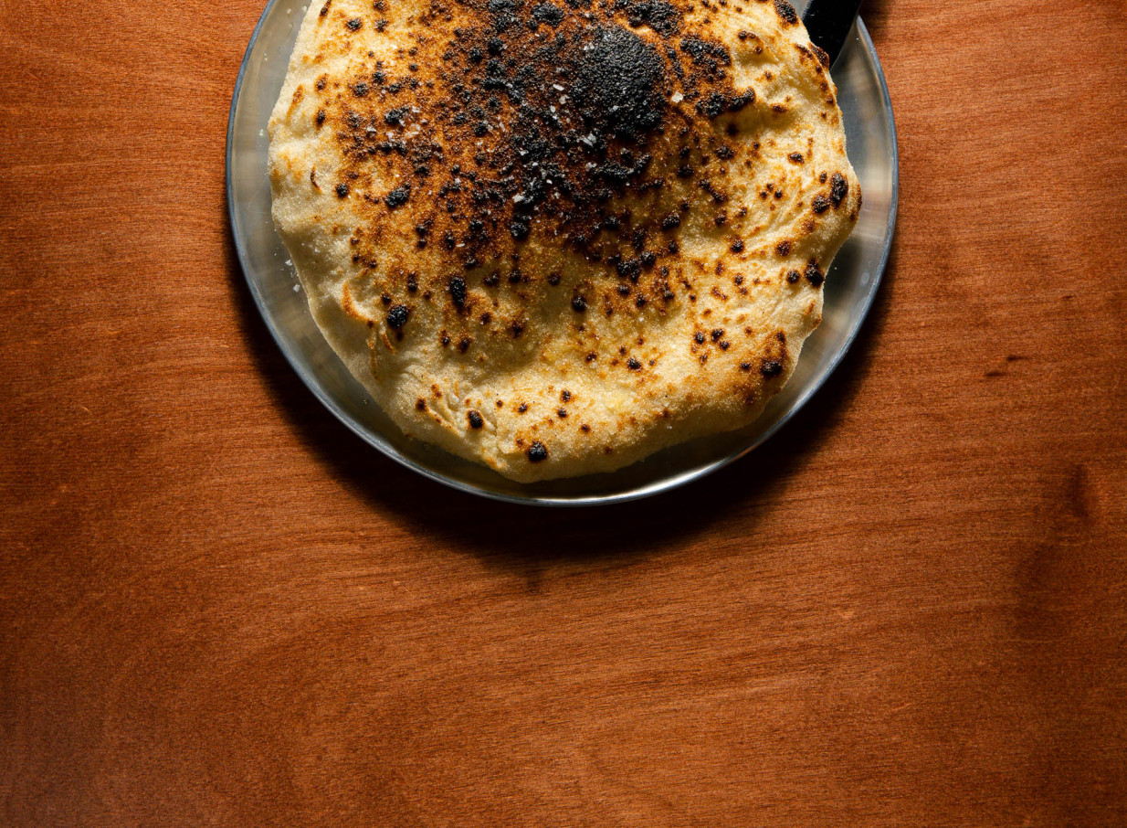 Flavour-driven charred flatbread from The Hilltop x 5th Street's catering in Christchurch.