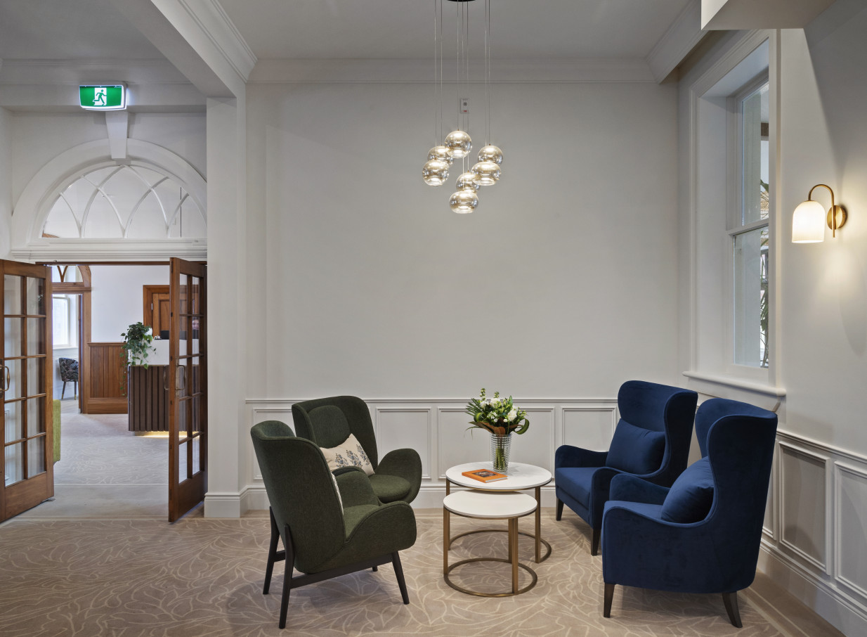 The Beaux-Arts inspired lobby of The Clements Hotel in Waikato, featuring luxurious seating and a modern chandelier.