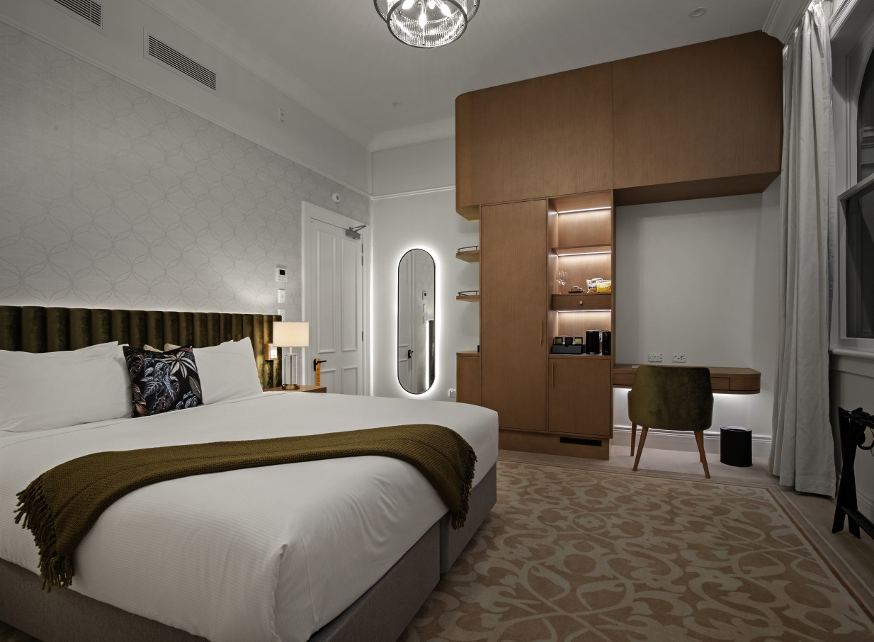 A stylish hotel bedroom blending Beaux-Arts elegance and modern luxury at The Clements Hotel in Waikato.
